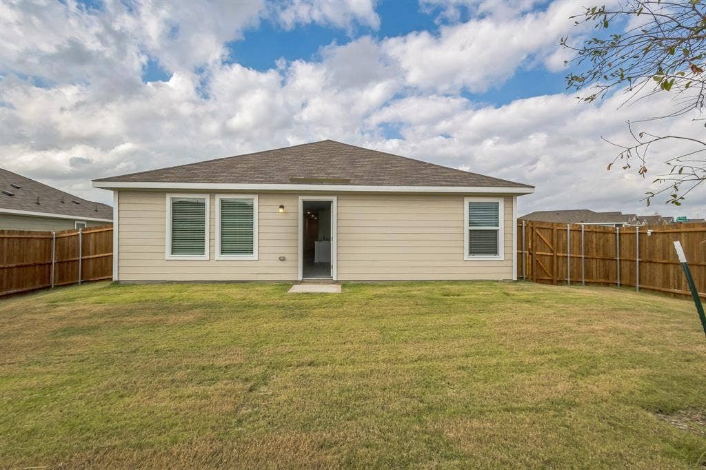 7904 Thornton Drive, McKinney, TX 75071 Expansive backyard with a brown privacy fence and a light-colored siding exterior
