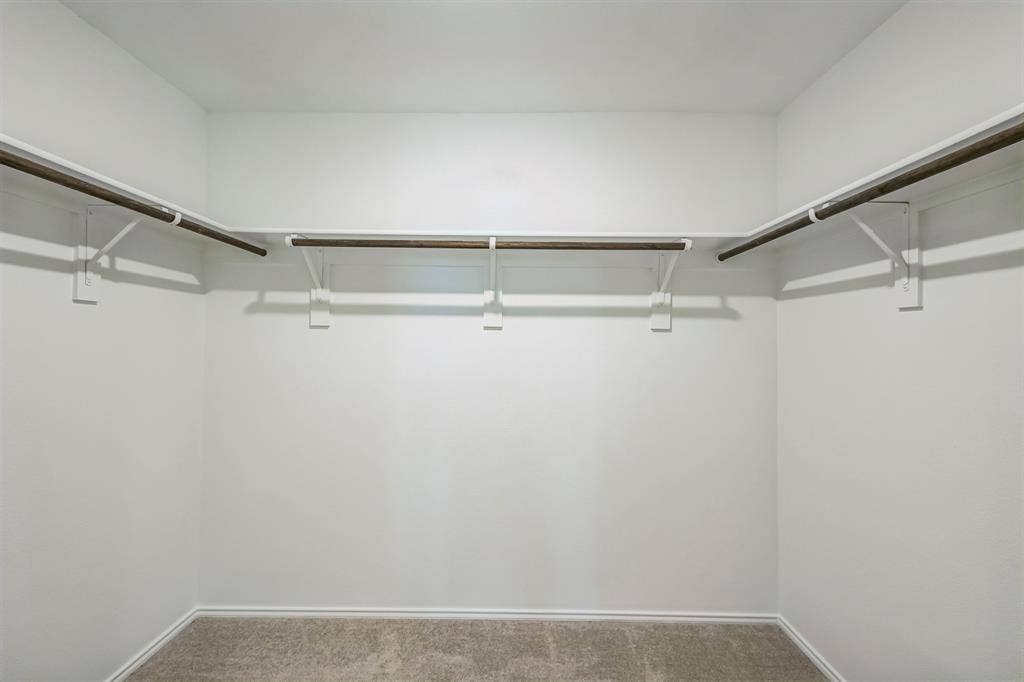 7904 Thornton Drive, McKinney, TX 75071 Integrated shelving and closet rods, light-toned carpeting, and painted walls