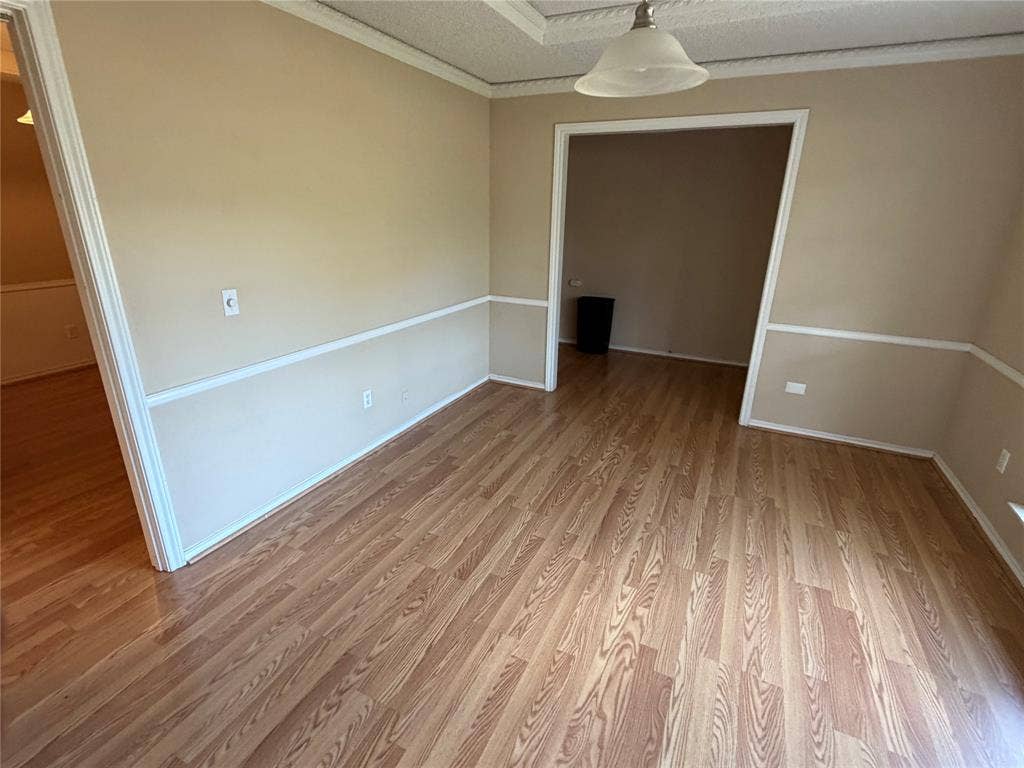 3912 Bandera Drive, Plano, TX 75074 Wood-finish flooring throughout, chair rail detailing, and a neutral color palette