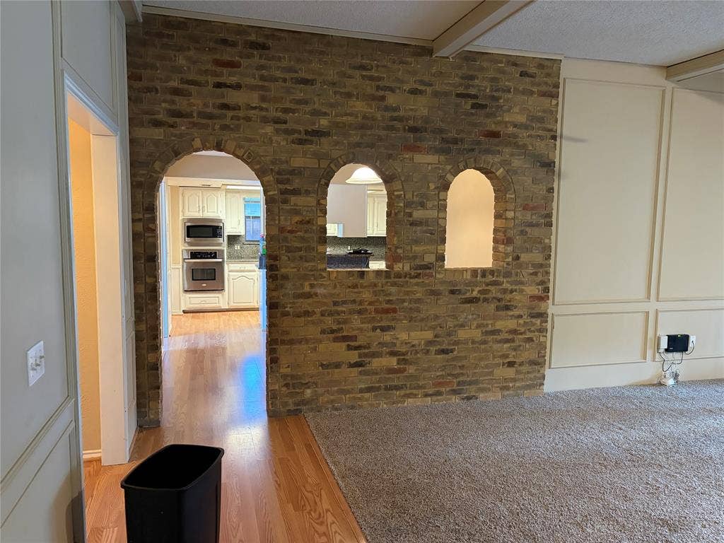 3912 Bandera Drive, Plano, TX 75074 Brick archways featuring a built-in kitchen pass-through