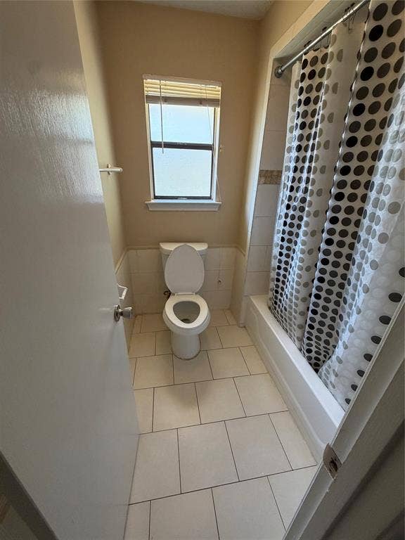 3912 Bandera Drive, Plano, TX 75074 White tile flooring, a window with blinds, a built-in bathtub, and ceramic wall tiling
