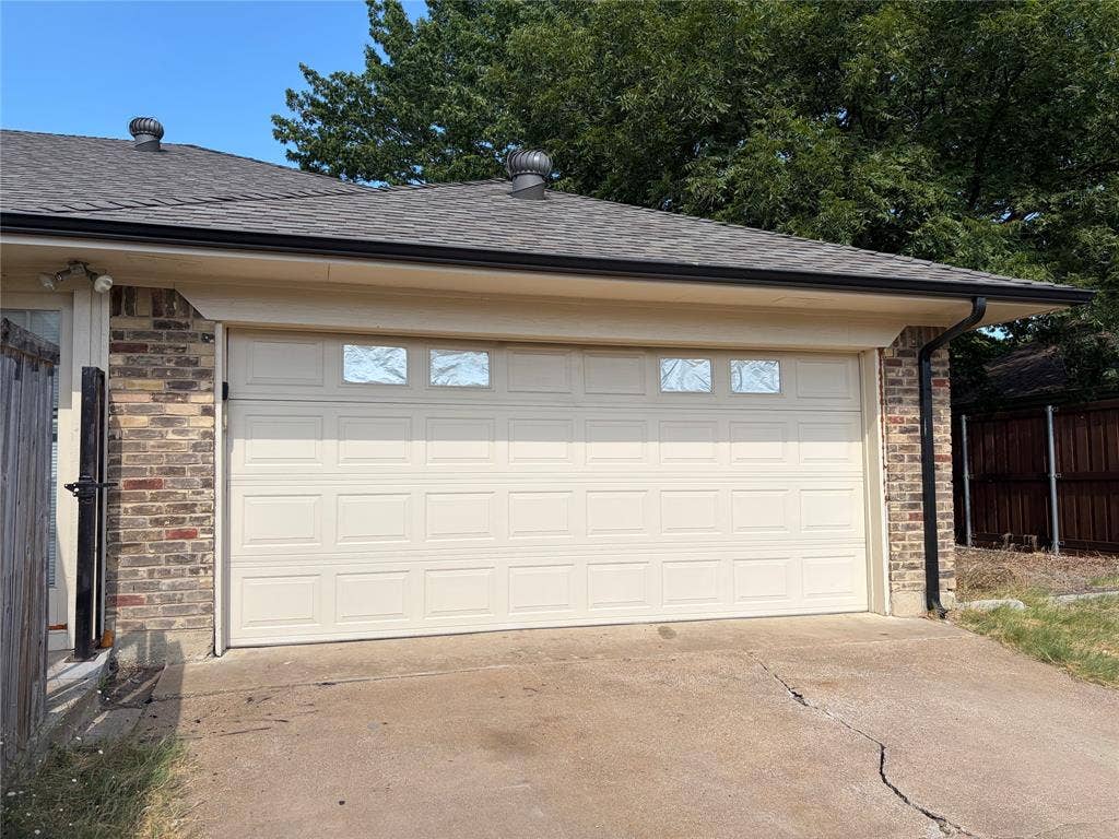 3912 Bandera Drive, Plano, TX 75074 Brick veneer exterior with an attached garage featuring paneled doors