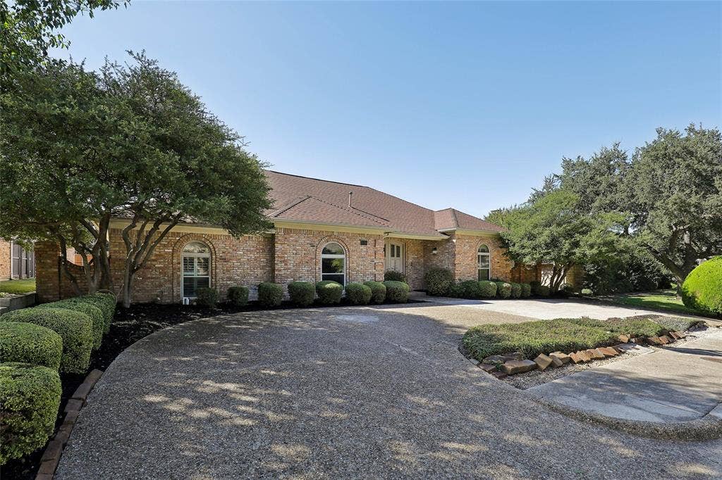 5716 Plumtree Drive, Dallas, TX 75252 Brick exterior with an asphalt shingle roof