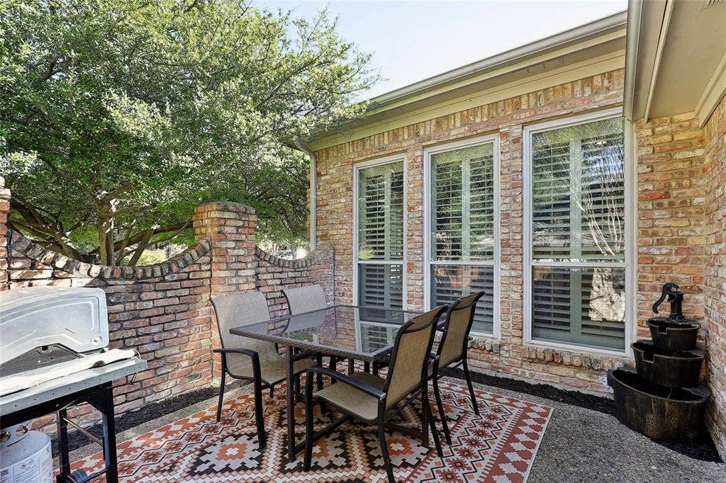5716 Plumtree Drive, Dallas, TX 75252 Courtyard dining, just outside of the kitchen. A great place to grill!