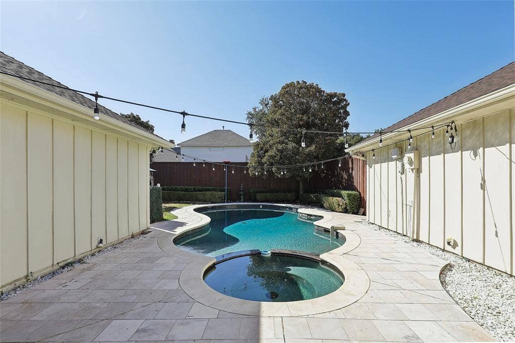 5716 Plumtree Drive, Dallas, TX 75252 Private backyard featuring a free-form pool with an integrated spa