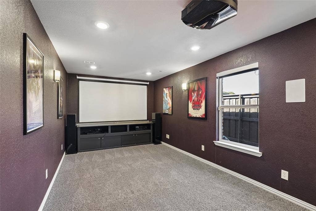 5716 Plumtree Drive, Dallas, TX 75252 -in projector, wall-mounted screen, recessed lighting, wall sconces, and built-in media console
