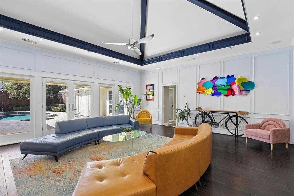 5716 Plumtree Drive, Dallas, TX 75252 Hardwood flooring, vaulted ceiling exposed beams, recessed lighting, and wall paneling