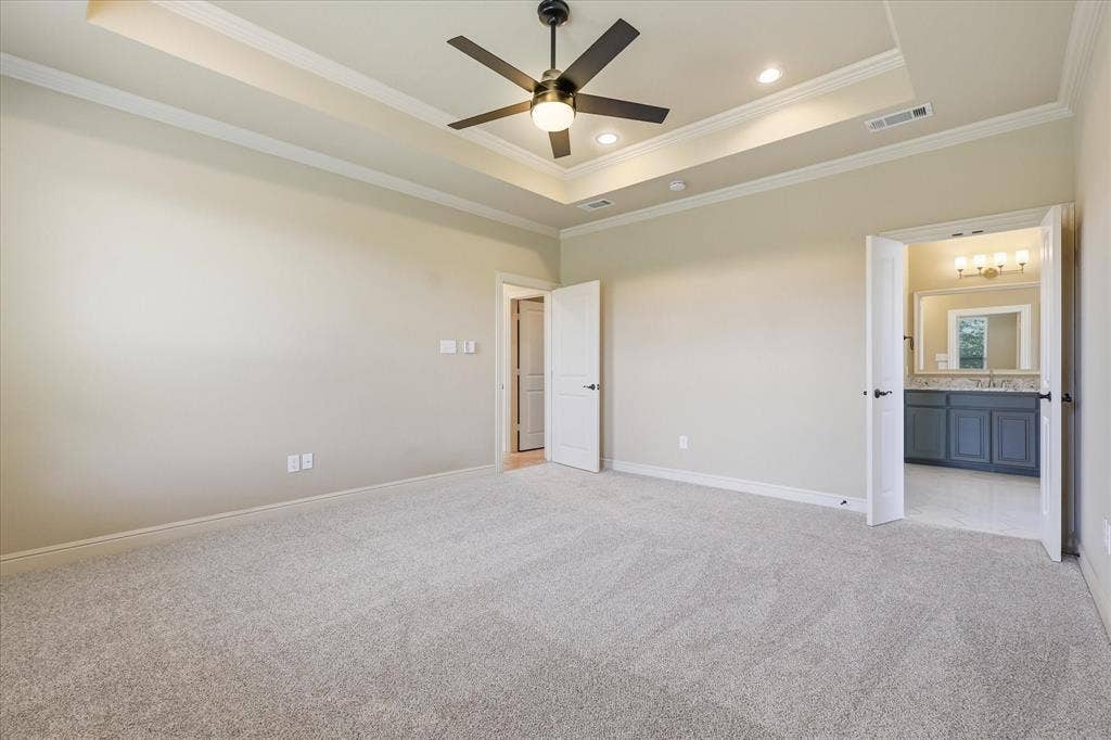 3110 Creek Haven Drive, Highland Village, TX 75077 Tray ceiling with recessed lighting, ceiling fan with integrated lighting, neutral wall-to-wall carpeting, and double-door entry