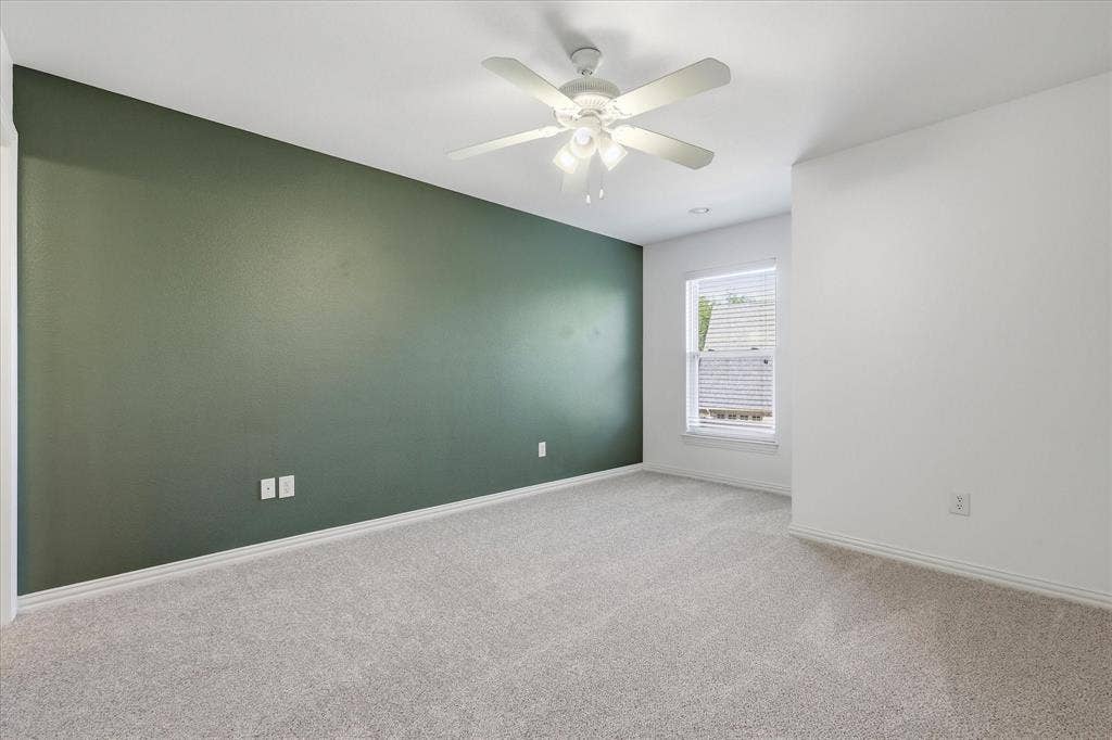 3110 Creek Haven Drive, Highland Village, TX 75077 Neutral carpet flooring, dark green accent wall, white ceiling with integrated multi-light ceiling fan, and recessed window