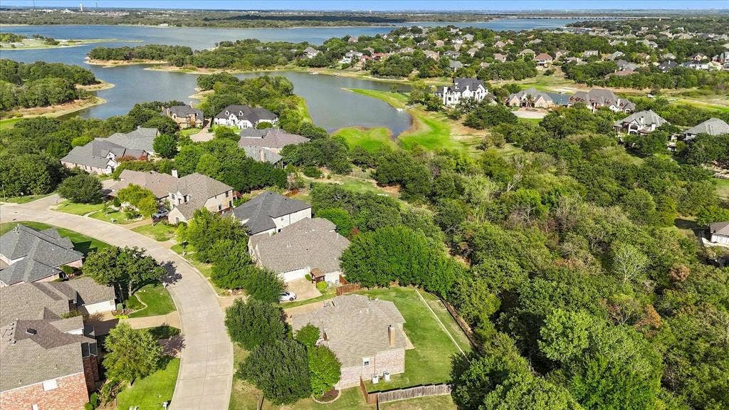 3110 Creek Haven Drive, Highland Village, TX 75077 Aerial perspective showcasing mature tree canopy, waterfront access, and residential lots