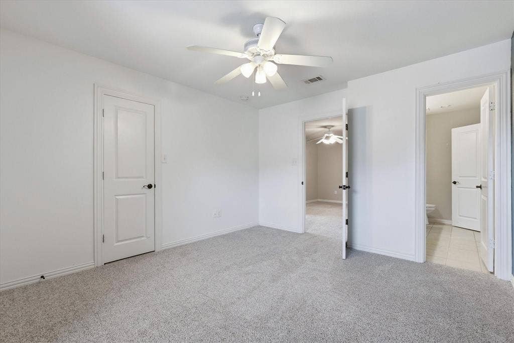 3110 Creek Haven Drive, Highland Village, TX 75077 Neutral-toned carpeted flooring, white interior doors, and a ceiling-mounted light fixture with a multi-blade fan