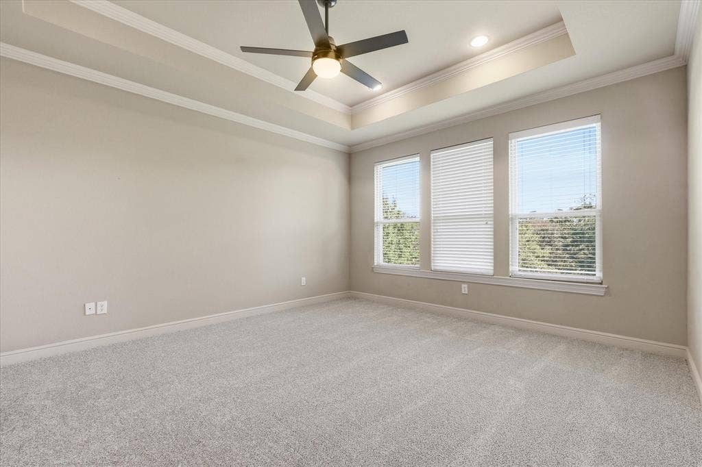 3110 Creek Haven Drive, Highland Village, TX 75077 Tray ceiling featuring crown molding, neutral carpeting, recessed lighting, and a modern ceiling fan with integrated lighting