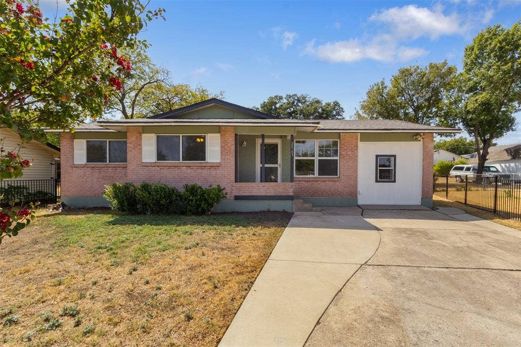 2563 Wood Valley Drive, Dallas, TX 75211 Single-story residence featuring a brick facade, covered entry, and a concrete driveway