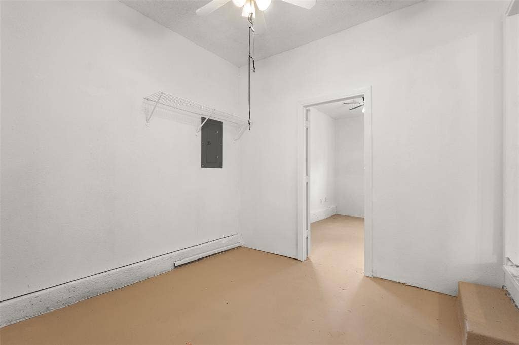 2563 Wood Valley Drive, Dallas, TX 75211 White painted walls with tan flooring