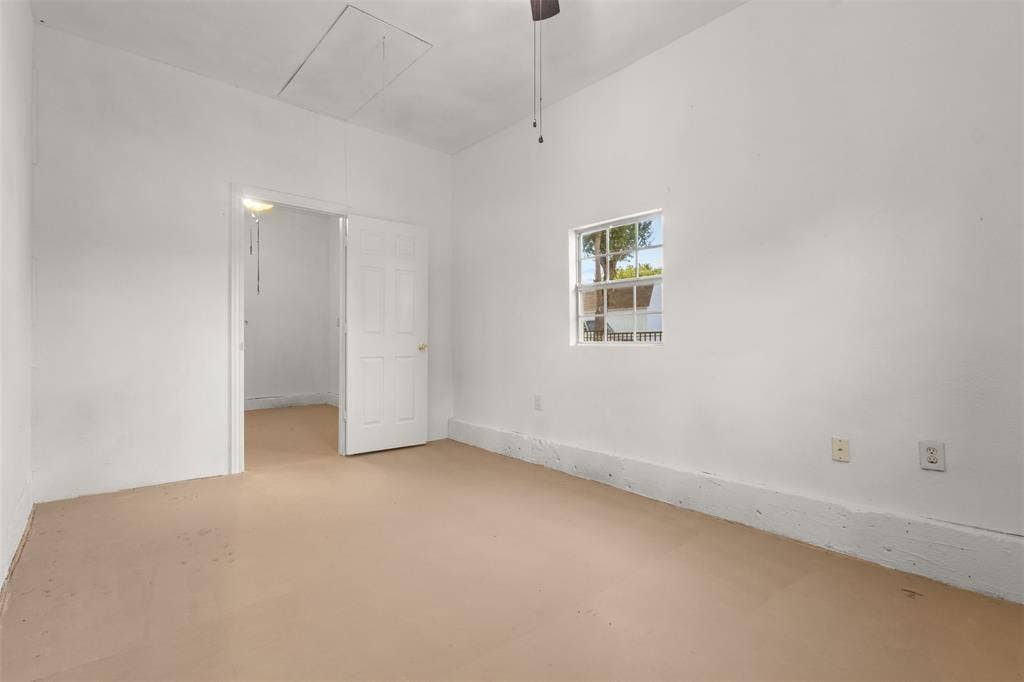 2563 Wood Valley Drive, Dallas, TX 75211 Neutral wall paint, ceiling fan, natural light, and an access panel