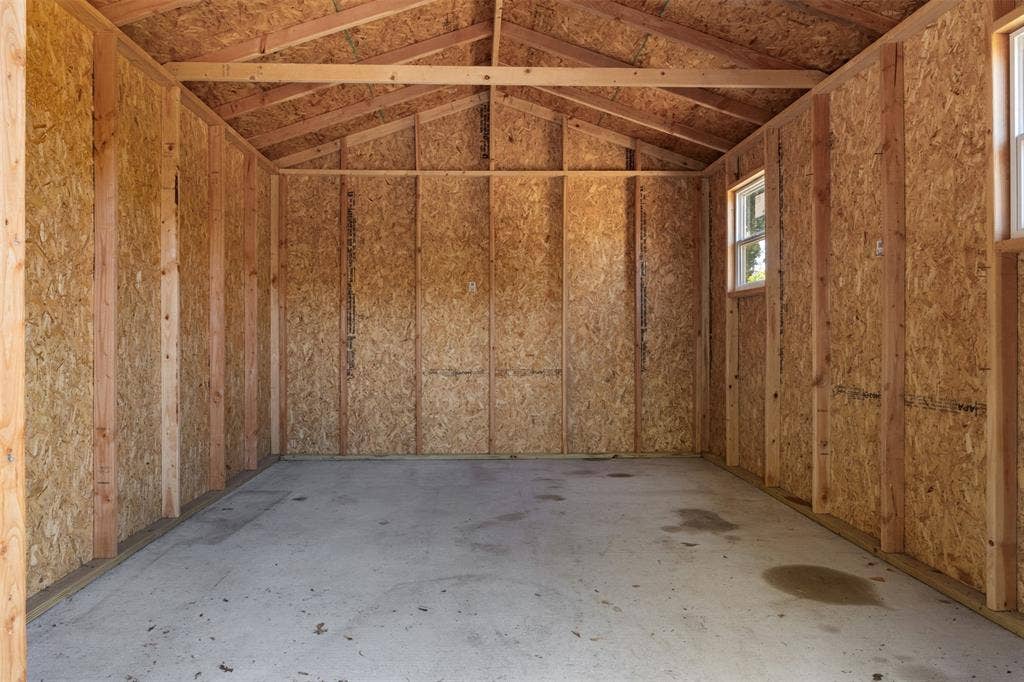 2563 Wood Valley Drive, Dallas, TX 75211 Unfinished interior with exposed wood framing and oriented strand board walls