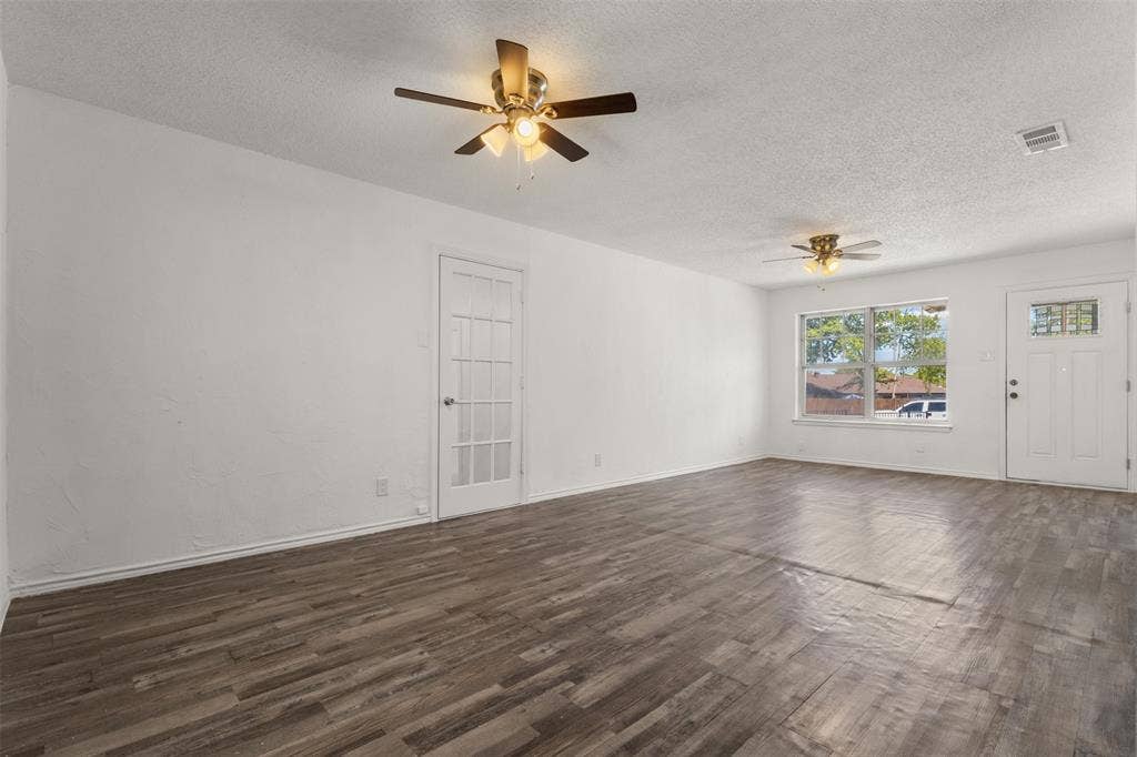 2563 Wood Valley Drive, Dallas, TX 75211 Wood-finish flooring, white painted walls, ceiling fans with integrated lighting, and a white paneled door with glass inserts