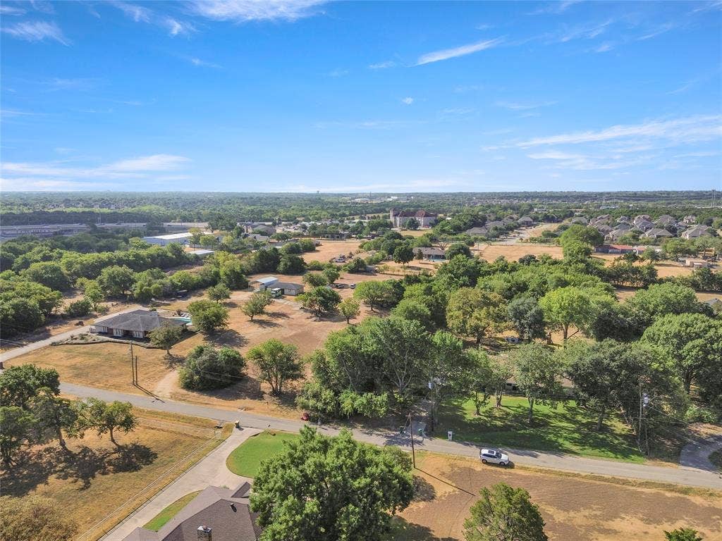1022 Sherman Drive, Cedar Hill, TX 75104 Expansive property featuring mature trees and open land, with a paved road visible