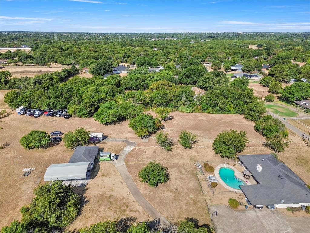 1022 Sherman Drive, Cedar Hill, TX 75104 Expansive property featuring a main residence with a swimming pool, a separate outbuilding with a metal roof, and mature trees