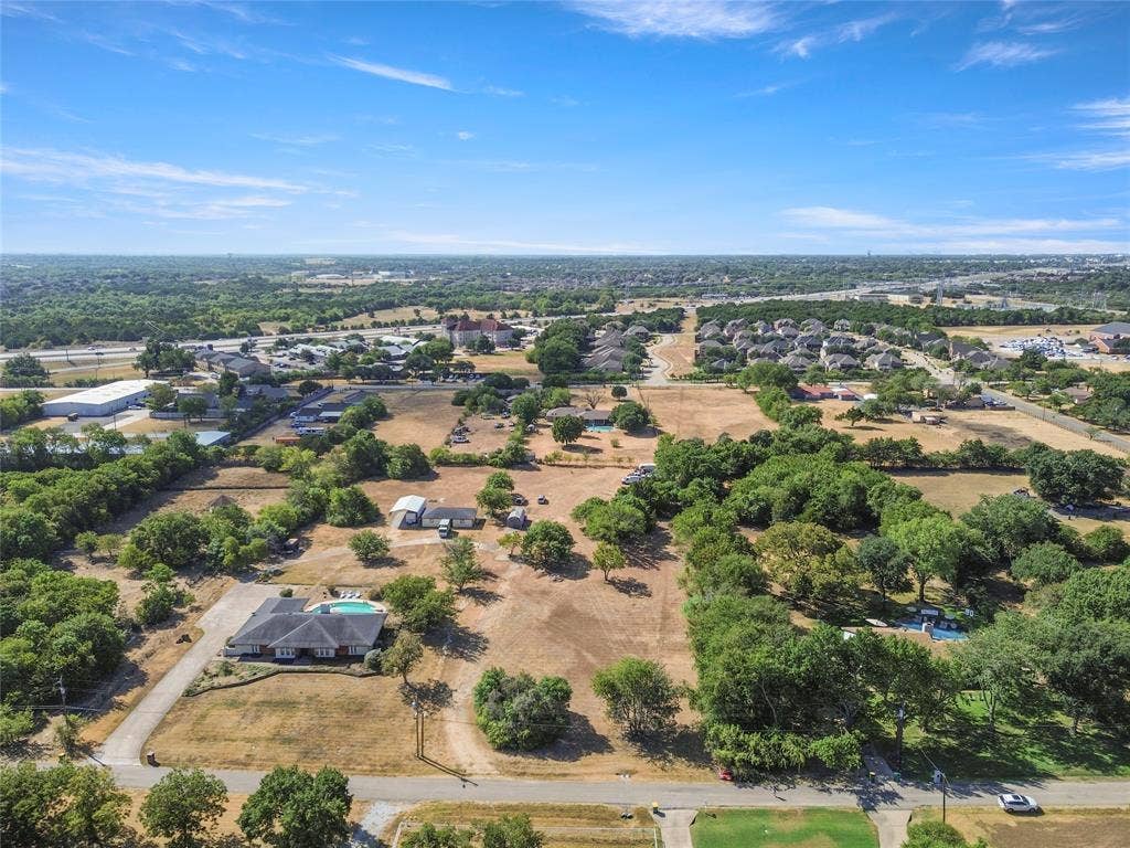 1022 Sherman Drive, Cedar Hill, TX 75104 Expansive property featuring a single-story residence, private swimming pool, mature trees, and a long paved driveway