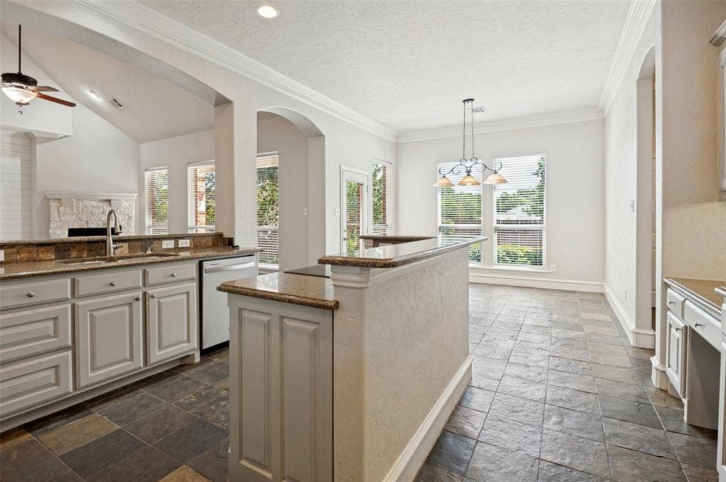 806 Cobblestone Court, Cedar Hill, TX 75104 Kitchen featuring granite countertops, light-toned cabinetry, tile flooring, and integrated appliances