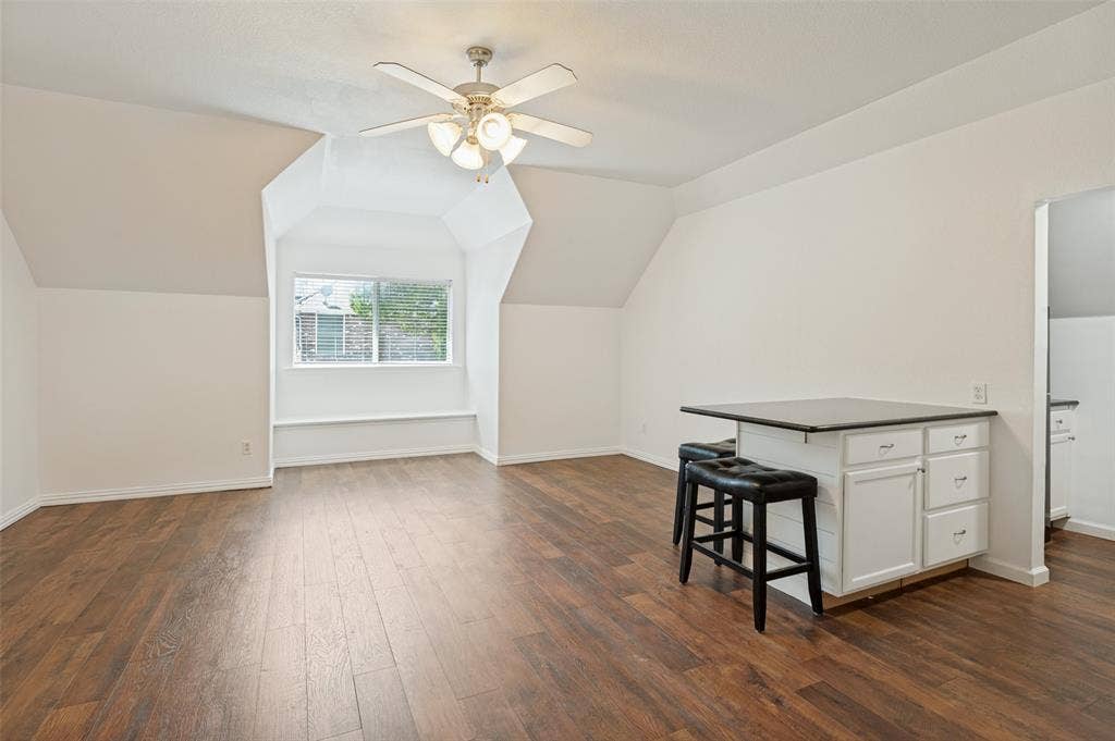 806 Cobblestone Court, Cedar Hill, TX 75104 Wood-finish flooring, built-in window seating, recessed window, white cabinetry, and ceiling fan with integrated lighting