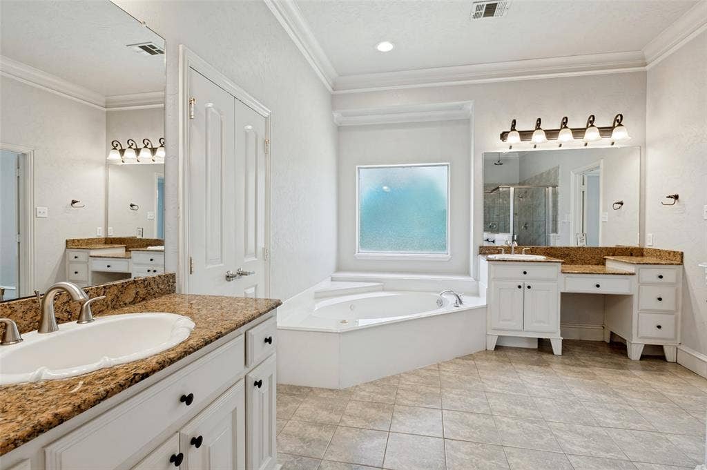 806 Cobblestone Court, Cedar Hill, TX 75104 Spacious bathroom featuring dual vanities with stone countertops, a built-in soaking tub, a large tiled shower, and tile flooring