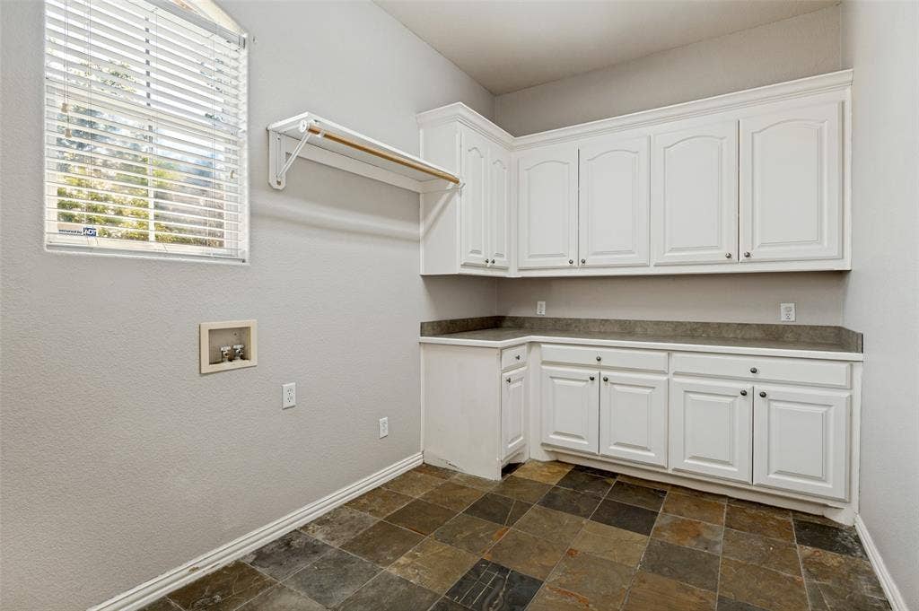 806 Cobblestone Court, Cedar Hill, TX 75104 Slate-style floor tile, white shaker-style cabinetry, and dark-toned countertops