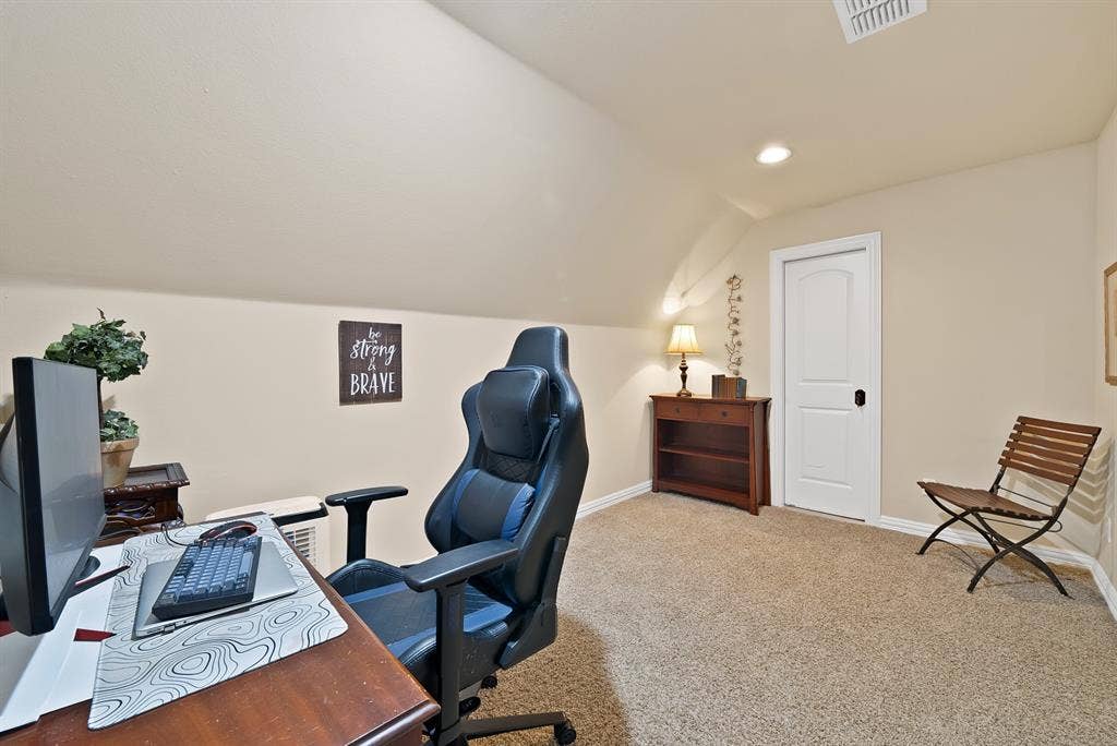 Carpeted flooring, vaulted ceiling, recessed lighting, built-in shelving, paneled interior door