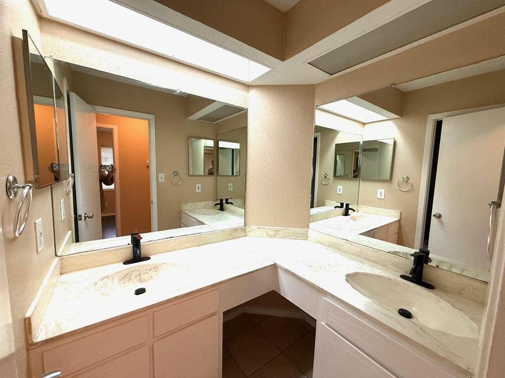 2705 Tanglewood Drive, Lancaster, TX 75134 Dual basin vanity with integrated sinks, expansive counter space, and wall-mounted mirrors