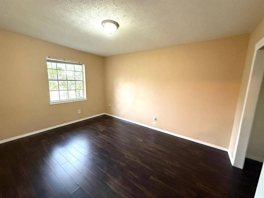 2705 Tanglewood Drive, Lancaster, TX 75134 Wood-finish flooring, neutral wall tones, and a window with natural light