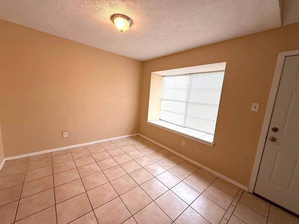2705 Tanglewood Drive, Lancaster, TX 75134 Tile flooring, neutral wall tones, window with horizontal blinds, and a ceiling-mounted light fixture
