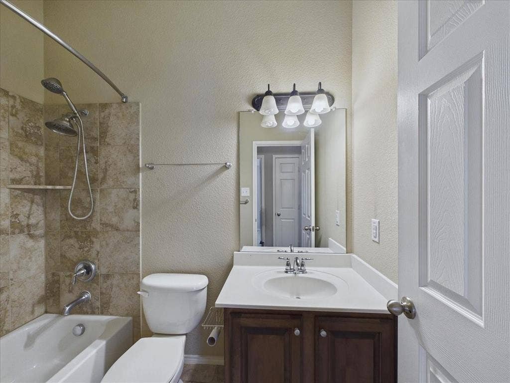 Tub and shower combination with tiled surround and built-in shelf