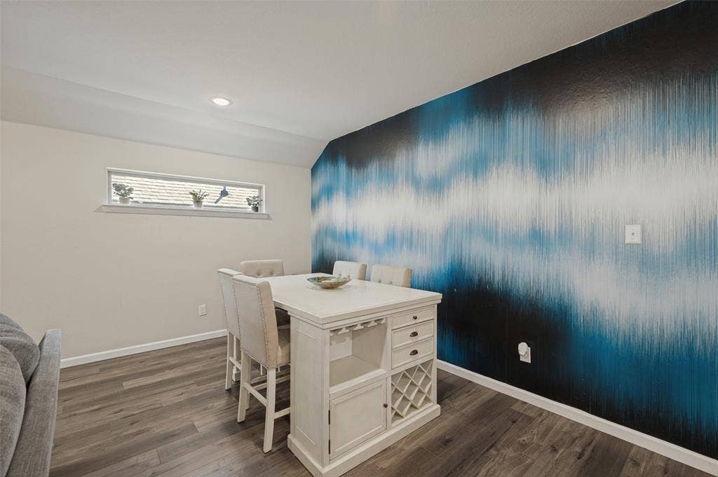 632 Cherry Hills Road, Red Oak, TX 75154 Recessed ceiling lighting, wood-finish flooring, accent wall with graphic pattern, horizontal window, and white trim molding