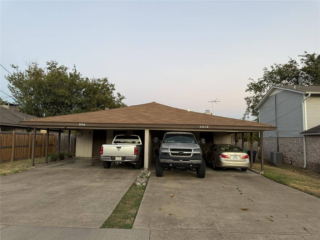 Duplex property featuring a hip roof, two dedicated carport spaces, and a concrete driveway