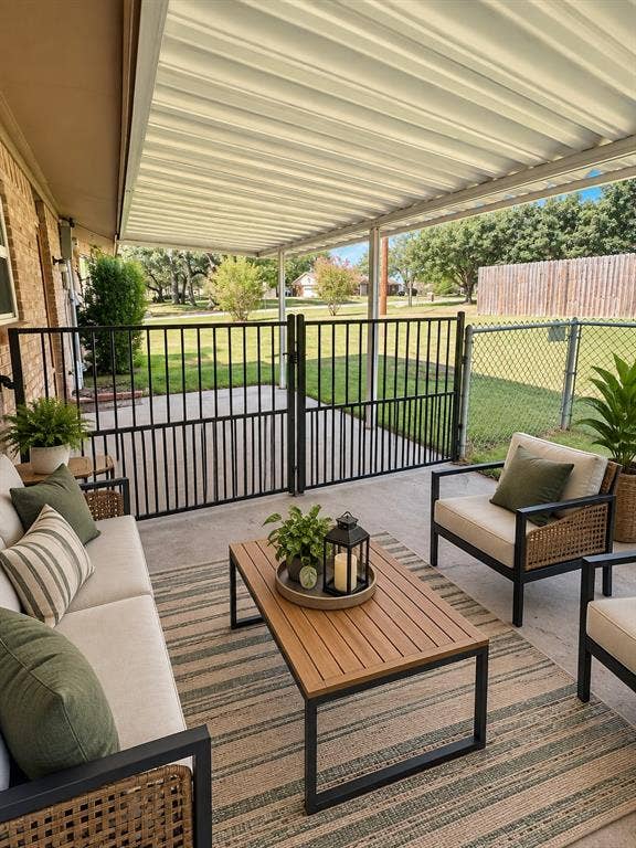 102 Rye Place, Gun Barrel City, TX 75156 Covered patio featuring a solid roof structure, concrete flooring, and a black metal fence