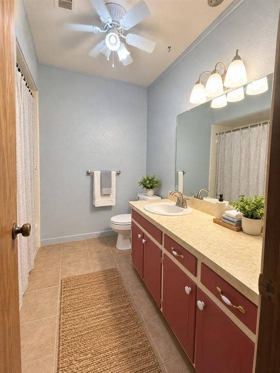 102 Rye Place, Gun Barrel City, TX 75156 Bathroom featuring a single vanity with a laminate countertop, red cabinetry, and a ceiling fan