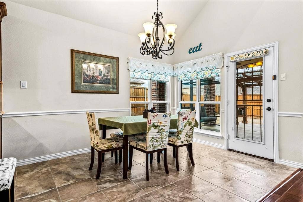 12467 Fallcreek Drive, Frisco, TX 75035 Vaulted ceiling, decorative chandelier, bay windows, glass-paneled door, and tile flooring