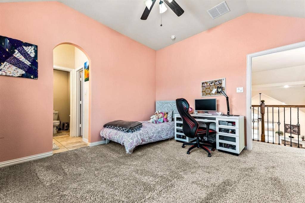 12467 Fallcreek Drive, Frisco, TX 75035 Vaulted ceiling with a ceiling fan, arched doorway, and carpet flooring