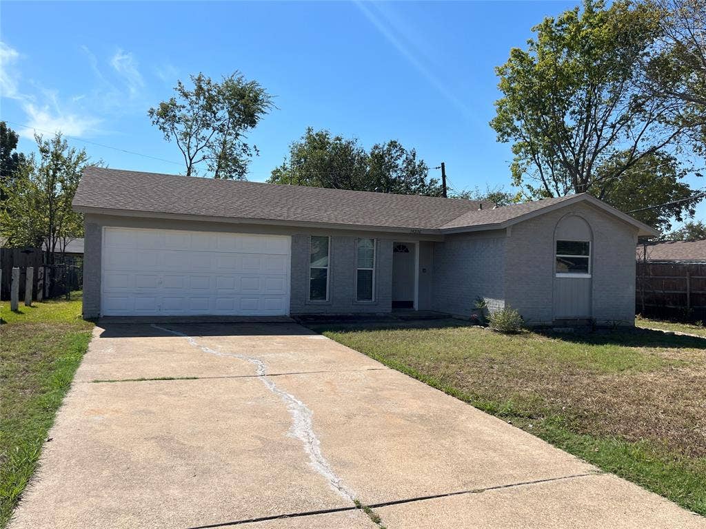 14206 Osage Drive, Balch Springs, TX 75180 Single-story residence with a two-car garage, concrete driveway, and a shingled roof