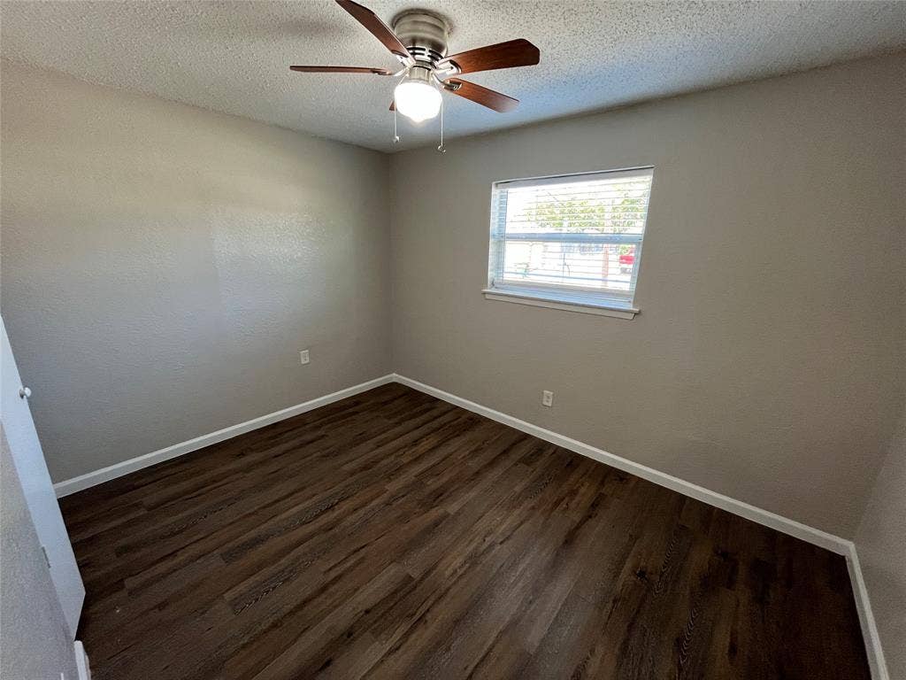 14206 Osage Drive, Balch Springs, TX 75180 Wood-finish flooring, ceiling fan with integrated lighting, and a window with blinds