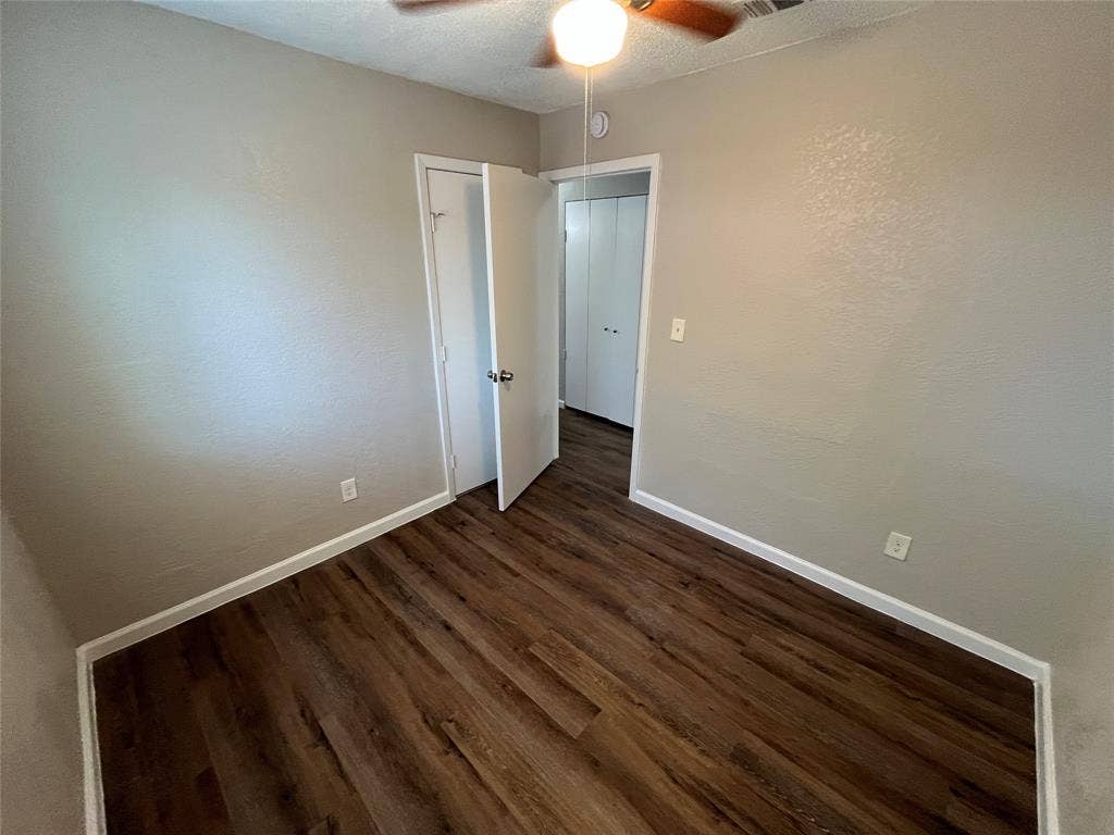 14206 Osage Drive, Balch Springs, TX 75180 Wood-finish flooring, neutral wall tones, ceiling fan with integrated lighting, and white trim