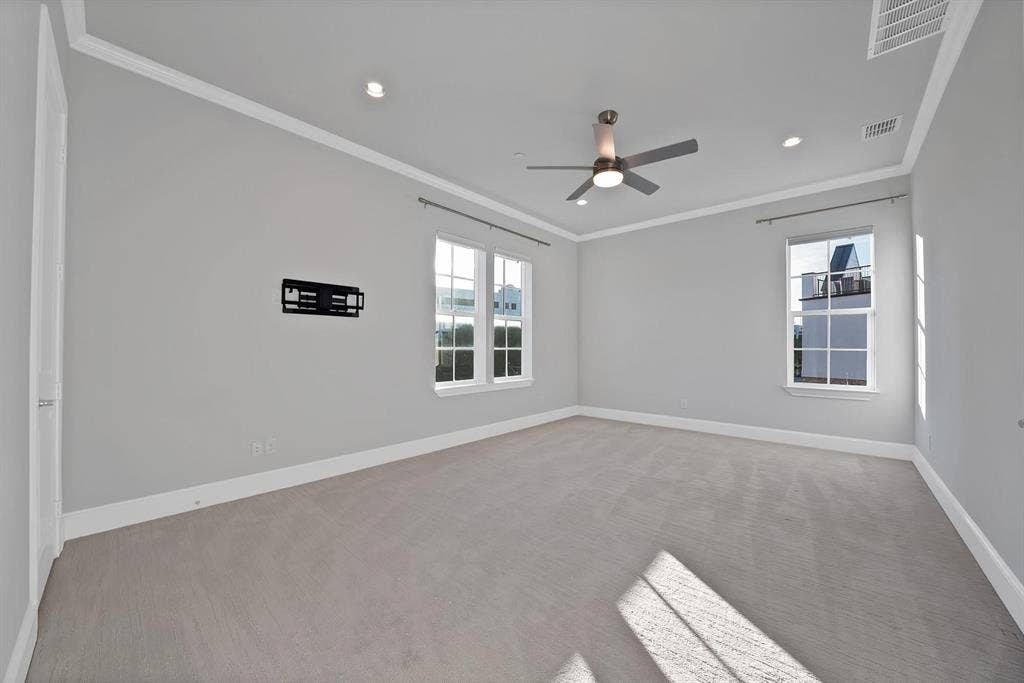 Recessed lighting, ceiling fan, crown molding, double windows, and carpet flooring
