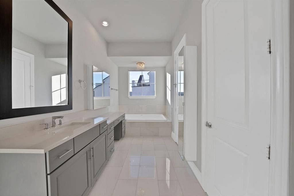 Dual vanity with modern gray cabinetry and light-toned countertops