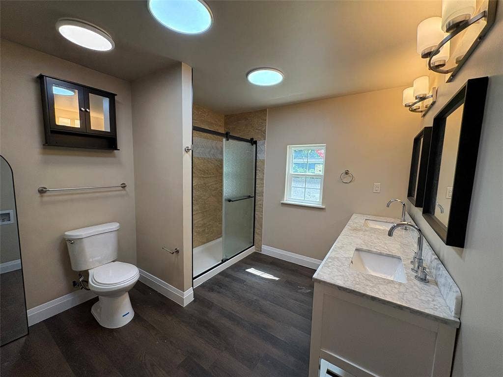 705 Vine Street, Euless, TX 76040 remodeled master bath with medicine cabinet, shower for 2, dual sink vanity with mirrors & lights, spacious shower, & linen closet