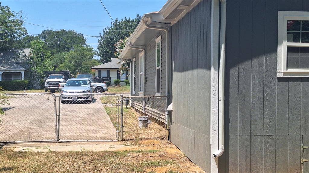 705 Vine Street, Euless, TX 76040 2nd 30 ft long driveway on right side of home with chain link gate at end into backyard