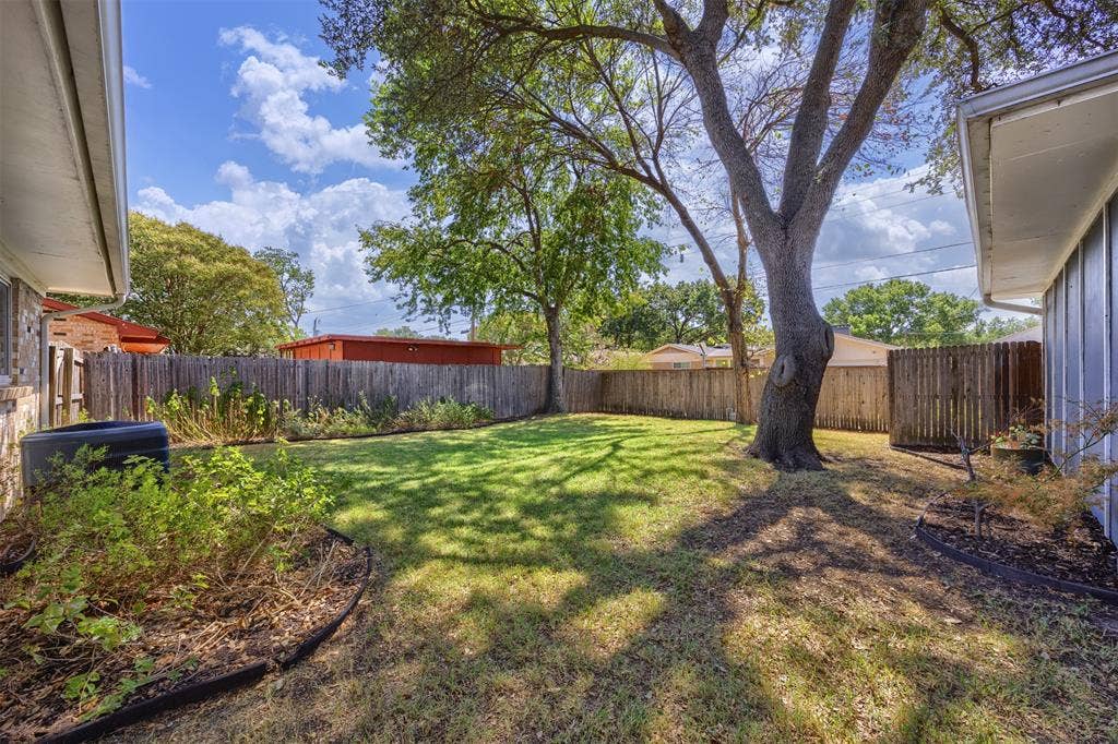 1118 Pacific Drive, Richardson, TX 75081 Fenced backyard with established lawn and mature trees