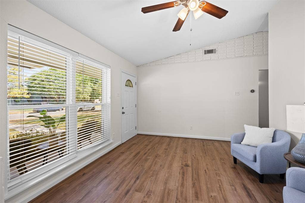 1118 Pacific Drive, Richardson, TX 75081 Vaulted ceiling with a ceiling fan, wood-finish flooring, and a window with blinds
