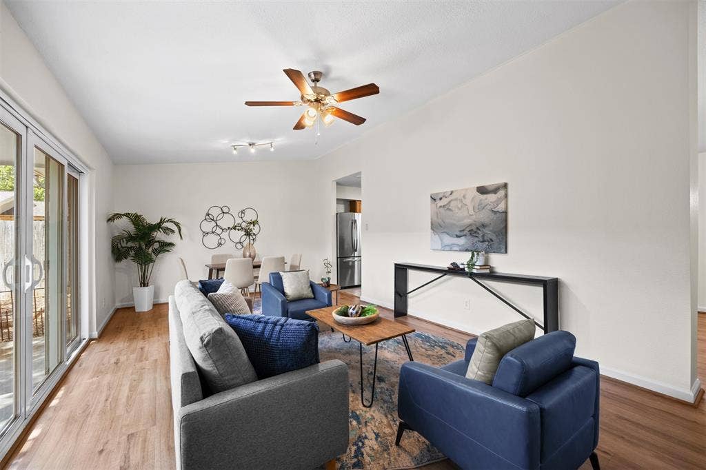 1118 Pacific Drive, Richardson, TX 75081 Vaulted ceilings, wood-finish flooring, ceiling fan, and sliding glass doors