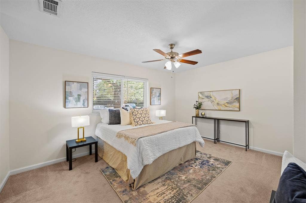 1118 Pacific Drive, Richardson, TX 75081 Recessed window with horizontal blinds, ceiling fan with integrated lighting, wall-to-wall carpeting, and neutral wall tones